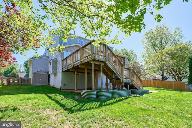 rear view of property with a deck, a fenced backyard, a lawn, a storage shed, and stairway