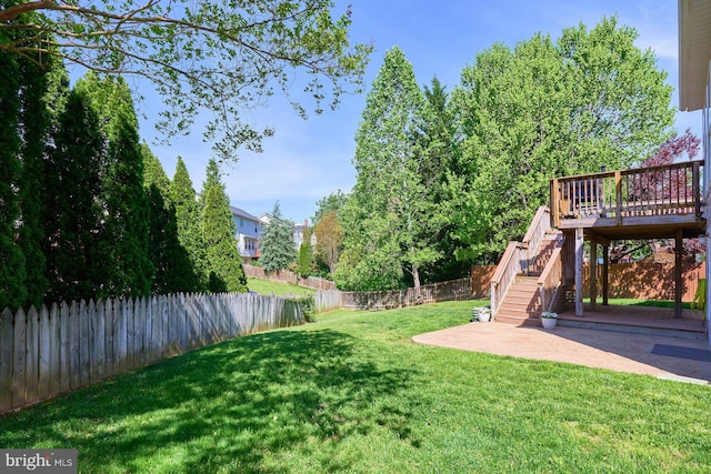 view of yard with stairs, a fenced backyard, a patio area, and a wooden deck