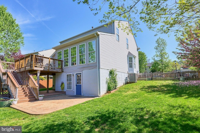 back of house featuring fence, a deck, stairway, a patio, and a yard