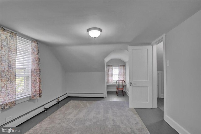 additional living space with baseboards, lofted ceiling, and baseboard heating