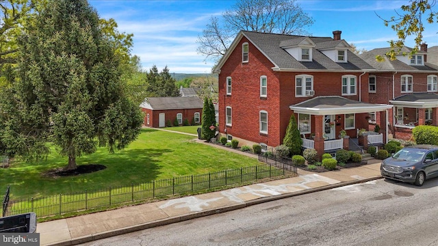view of front of home featuring covered porch, brick siding, fence private yard, and a front lawn