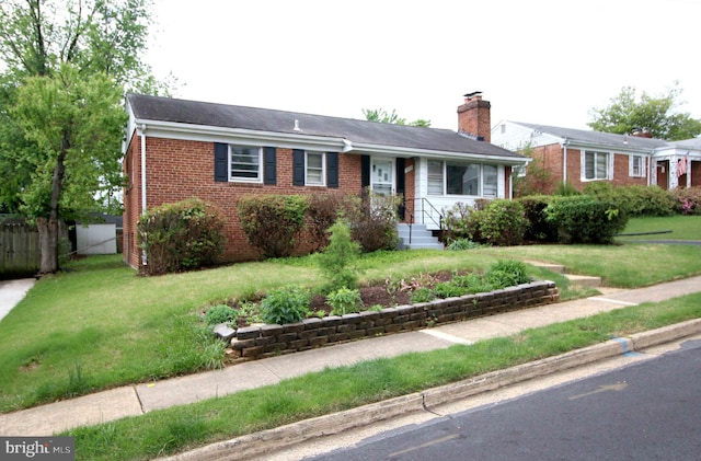 ranch-style house featuring brick siding and a chimney