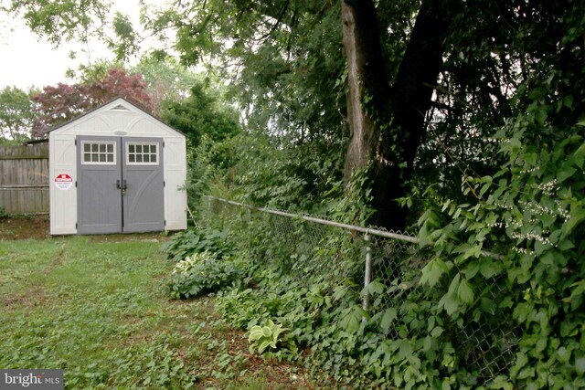 view of shed with fence