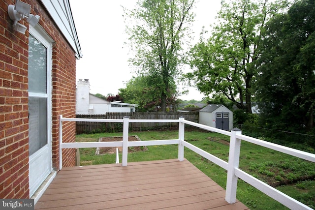 wooden terrace with a shed and an outdoor structure