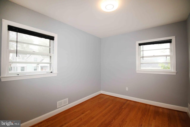 spare room featuring wood finished floors and baseboards
