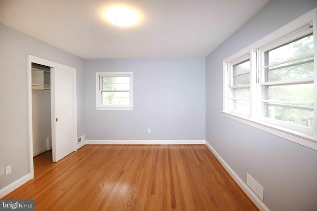 unfurnished bedroom featuring light wood finished floors and baseboards