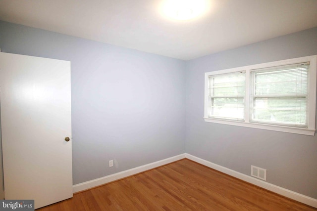 unfurnished room featuring light wood-style flooring and baseboards