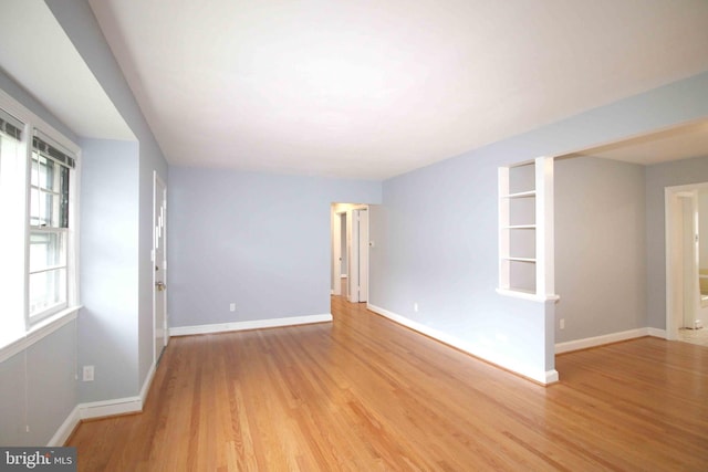 spare room featuring wood finished floors and baseboards