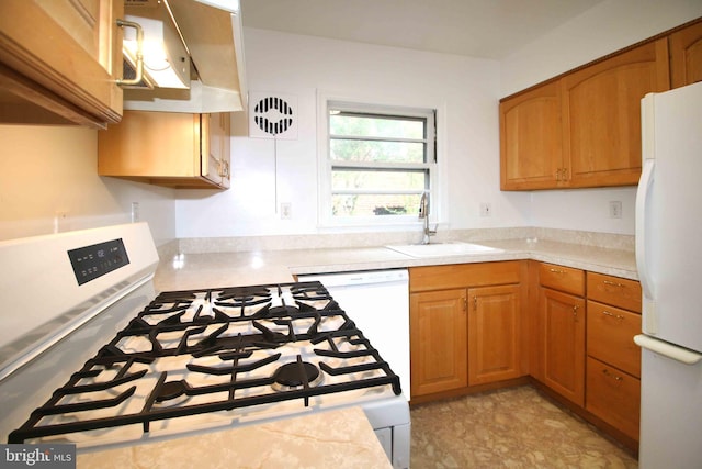 kitchen featuring white appliances, light countertops, a sink, and brown cabinetry