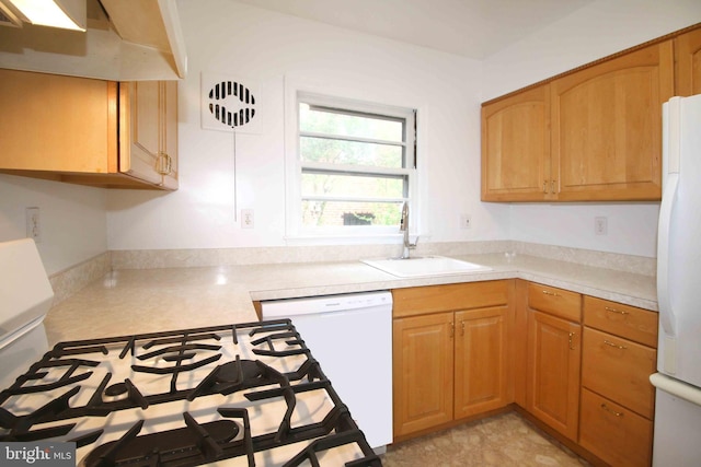 kitchen featuring a sink, white appliances, and light countertops