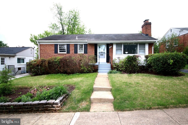 view of front of house featuring brick siding and a chimney