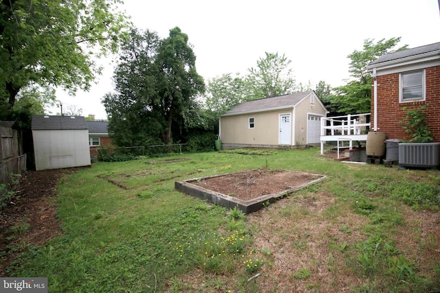 view of yard with an outbuilding, a shed, and central AC