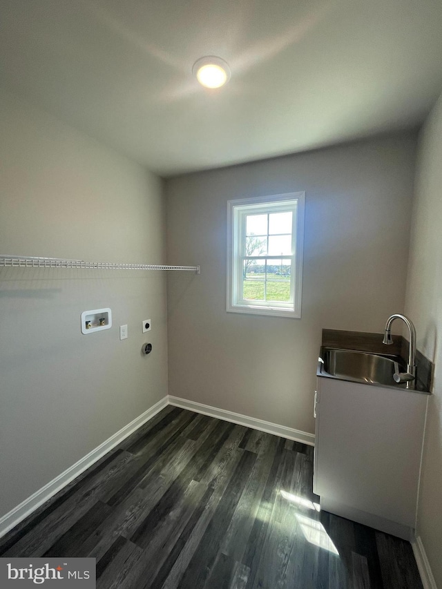 washroom featuring dark wood-style floors, a sink, baseboards, electric dryer hookup, and laundry area