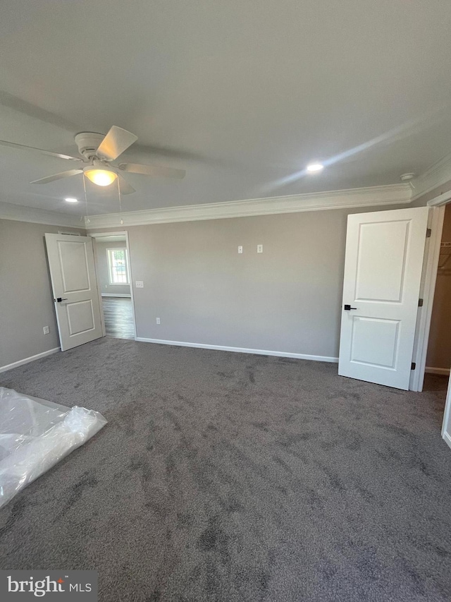 interior space featuring ceiling fan, baseboards, and ornamental molding