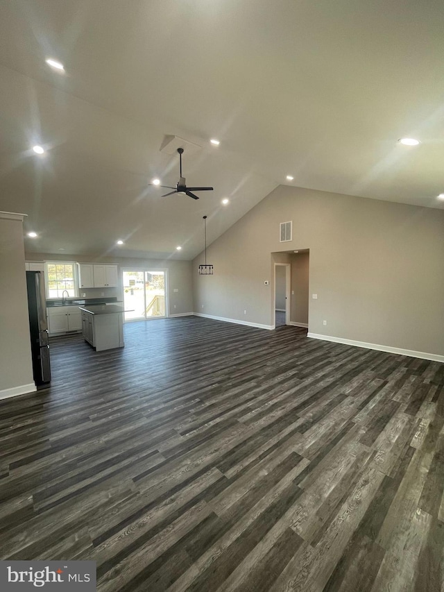 unfurnished living room with recessed lighting, visible vents, a ceiling fan, dark wood-type flooring, and baseboards