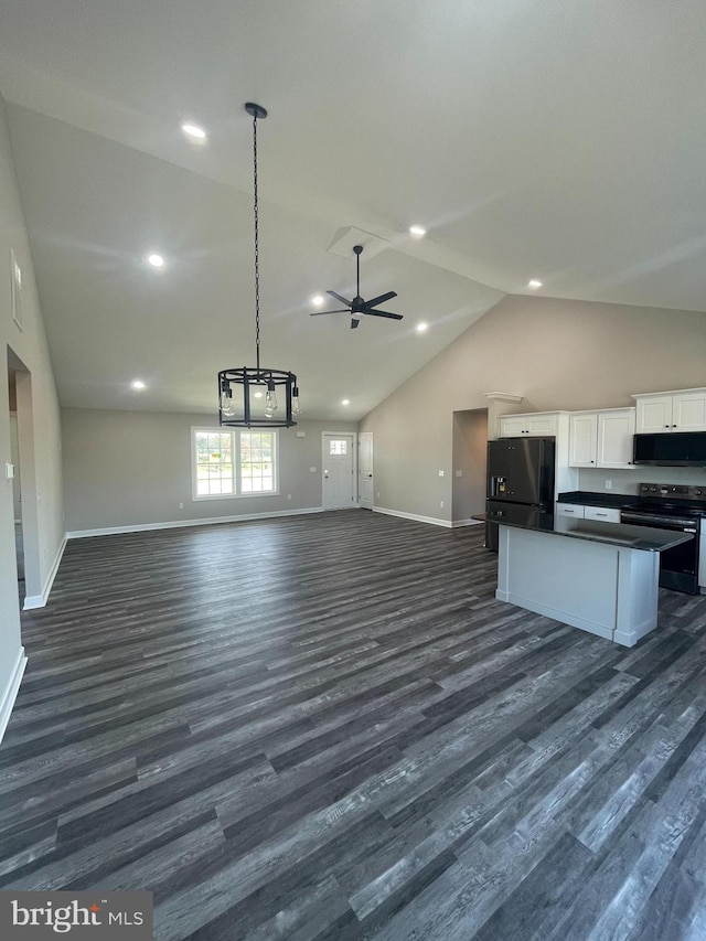 kitchen featuring dark wood-style floors, dark countertops, black appliances, open floor plan, and white cabinetry