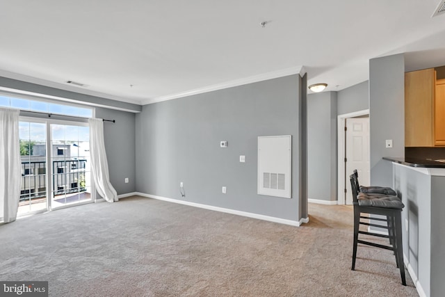 unfurnished living room with light carpet, visible vents, and ornamental molding