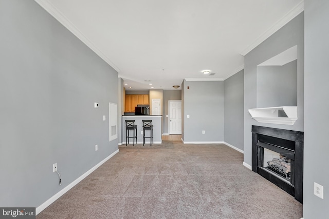 unfurnished living room featuring visible vents, light carpet, crown molding, baseboards, and a fireplace
