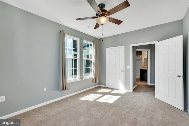 unfurnished bedroom with a ceiling fan, baseboards, and light colored carpet