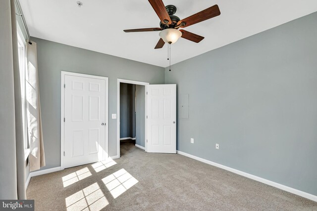 unfurnished bedroom with carpet floors, baseboards, and ceiling fan