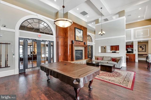 game room with a high ceiling, crown molding, and coffered ceiling