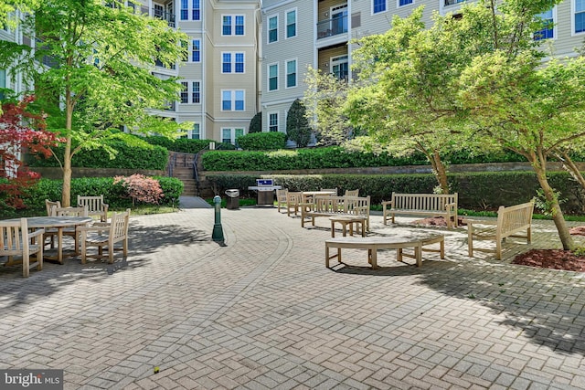 view of home's community with outdoor dining space and a patio area