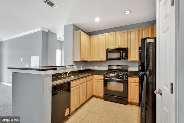 kitchen featuring visible vents, light brown cabinetry, a sink, and black appliances