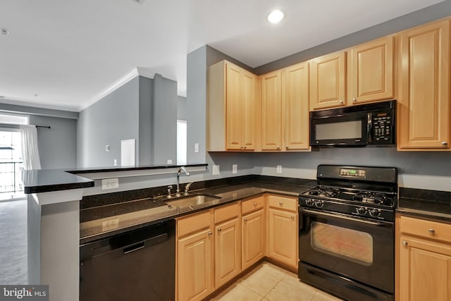 kitchen featuring light brown cabinets, a sink, and black appliances