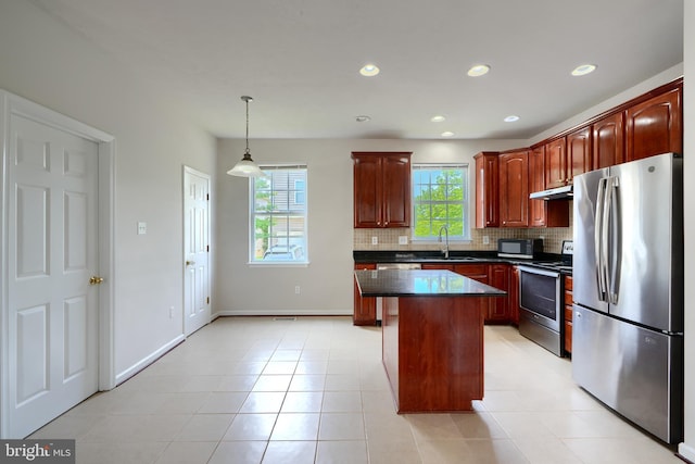 724 Tinker Rd, Middle River, MD 21220 - kitchen with stainless steel appliances, under cabinet range hood, a sink, dark countertops, and backsplash