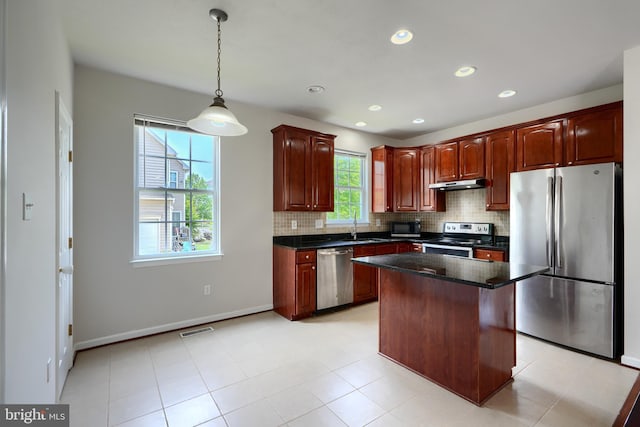 724 Tinker Rd, Middle River, MD 21220 - kitchen with stainless steel appliances, under cabinet range hood, a sink, backsplash, and recessed lighting