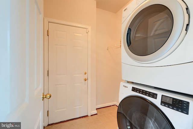 724 Tinker Rd, Middle River, MD 21220 - washroom featuring estacked washer and dryer, light tile patterned floors, and baseboards
