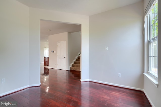 724 Tinker Rd, Middle River, MD 21220 - unfurnished room with stairs, wood-type flooring, plenty of natural light, and baseboards