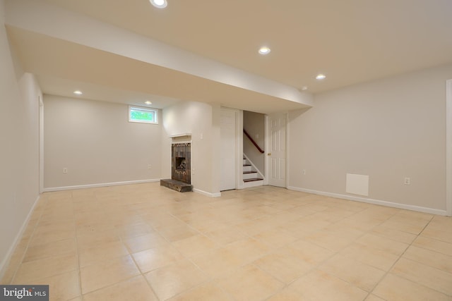 724 Tinker Rd, Middle River, MD 21220 - below grade area featuring a fireplace with raised hearth, stairway, recessed lighting, light tile patterned floors, and baseboards