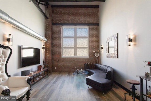 810 N Hancock St Unit 5, Philadelphia, PA 19123 - sitting room with a towering ceiling, wood finished floors, and brick wall
