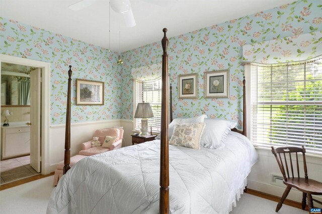 42 Old Farm Rd, Charlottesville, VA 22903 - bedroom featuring wainscoting, wood finished floors, wallpapered walls, a ceiling fan, and ensuite bath