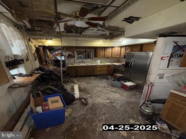 interior space featuring brown cabinetry, ceiling fan, and stainless steel fridge with ice dispenser