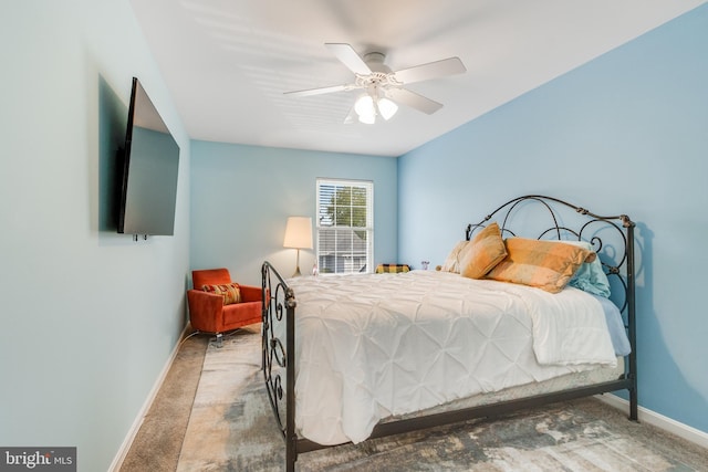 bedroom featuring baseboards, a ceiling fan, and carpet