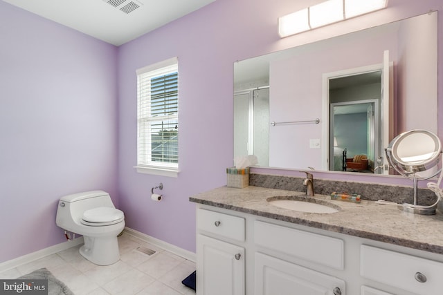 bathroom featuring visible vents, vanity, baseboards, and tile patterned floors