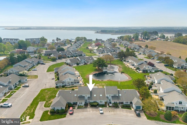 drone / aerial view featuring a residential view and a water view