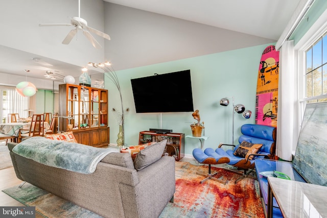 living area with high vaulted ceiling and ceiling fan