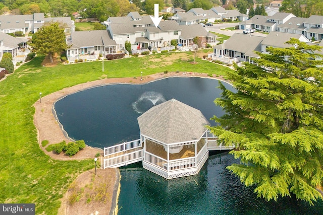 drone / aerial view featuring a water view and a residential view