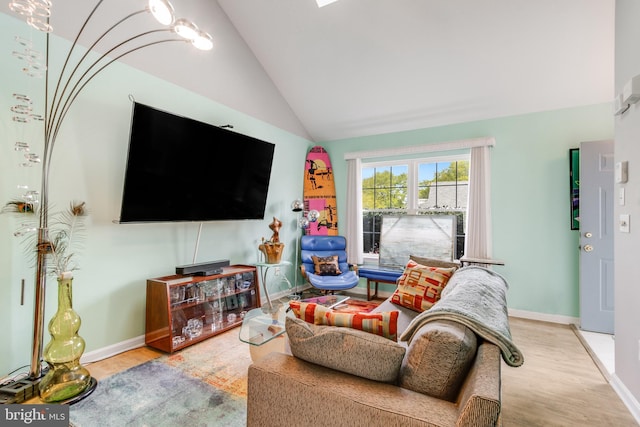 living room featuring vaulted ceiling, wood finished floors, and baseboards
