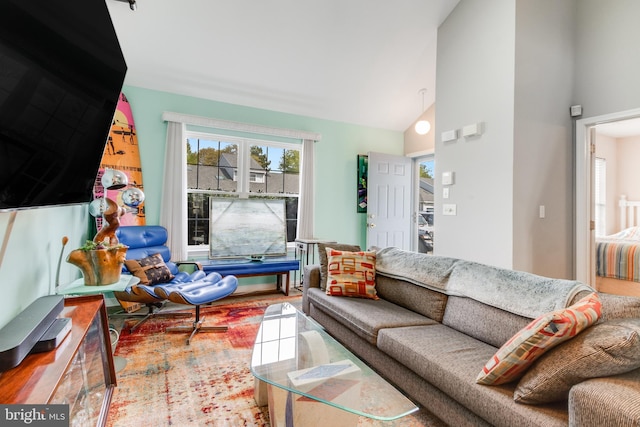 living room featuring high vaulted ceiling