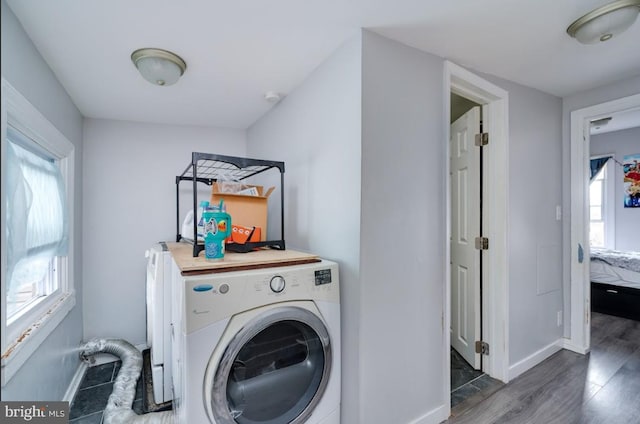 235 Maple St, Reading, PA 19602 - laundry room with baseboards, wood finished floors, laundry area, and washer / dryer