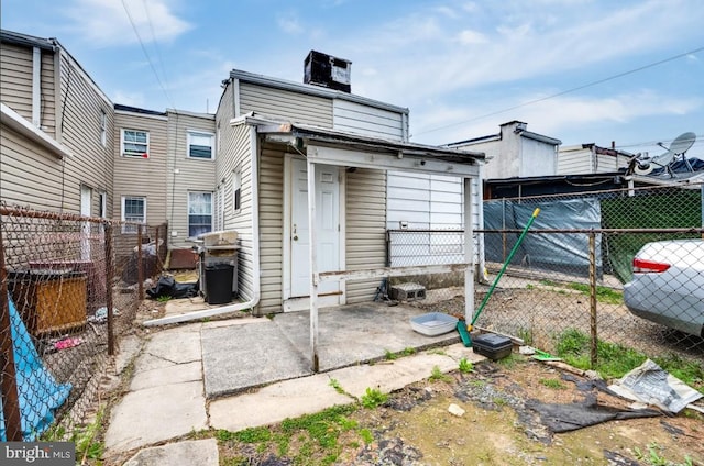 235 Maple St, Reading, PA 19602 - back of property with a fenced backyard and a chimney
