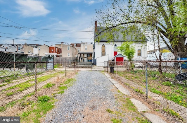 235 Maple St, Reading, PA 19602 - view of street with a gate, a residential view, and gravel driveway