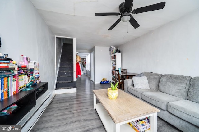 235 Maple St, Reading, PA 19602 - living area with wood finished floors, ceiling fan, and stairway