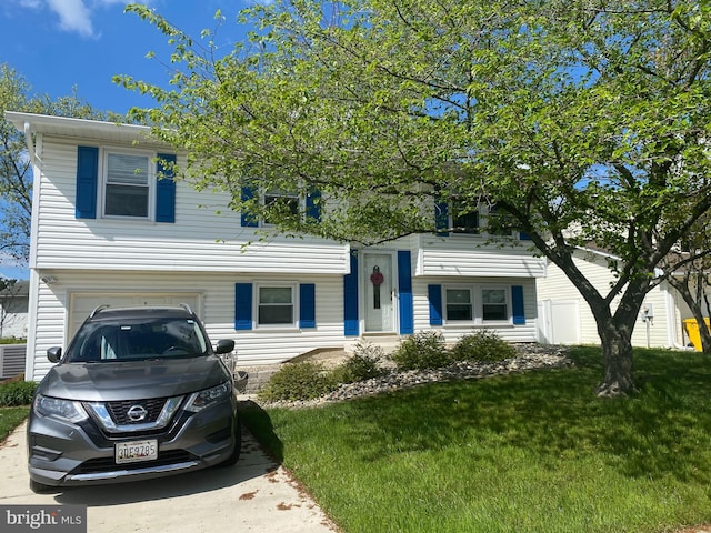 view of front of home featuring a garage and a front lawn