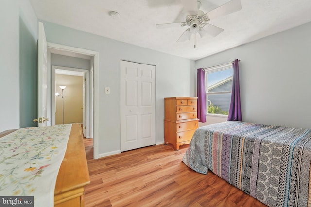 bedroom featuring light wood finished floors, ceiling fan, and baseboards