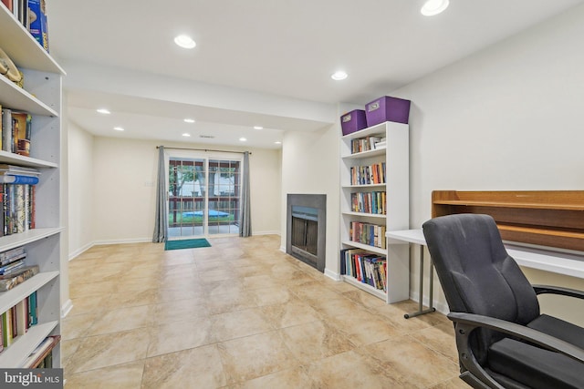 office with a fireplace, recessed lighting, and built in features
